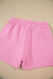 Pink cotton shorts with elastic waistband and cuffed hem