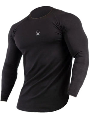 Black long sleeve performance top with crew neck and subtle spider logo detail.