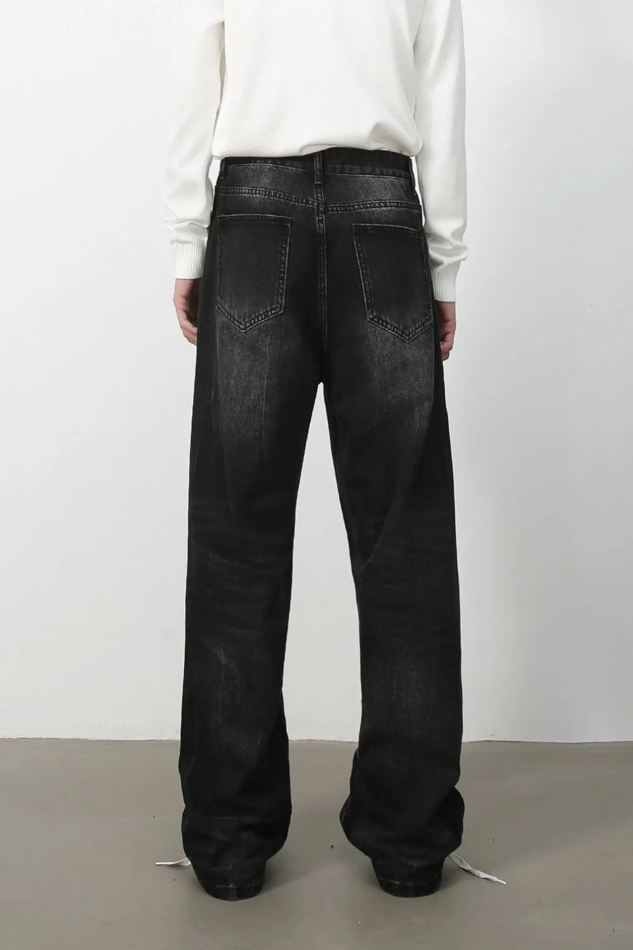Wide-leg distressed denim jeans in dark vintage wash with a relaxed fit.