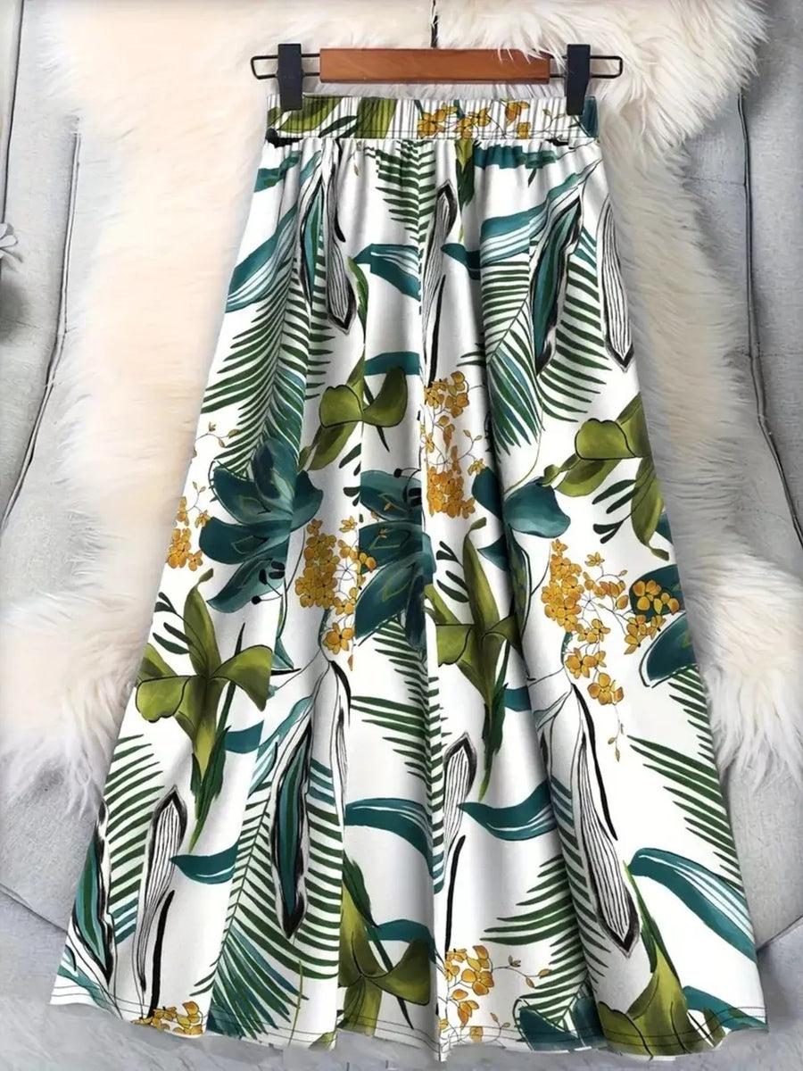 A-line skirt with elastic waist and green botanical print on white.