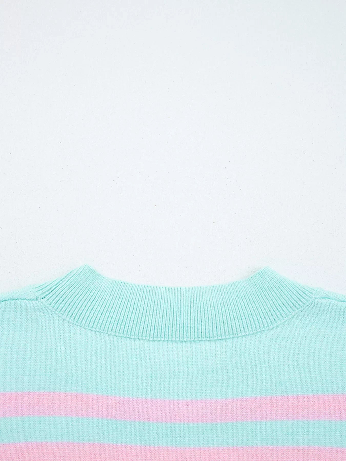 Multicolor striped cropped sweater with a ribbed mock neck.