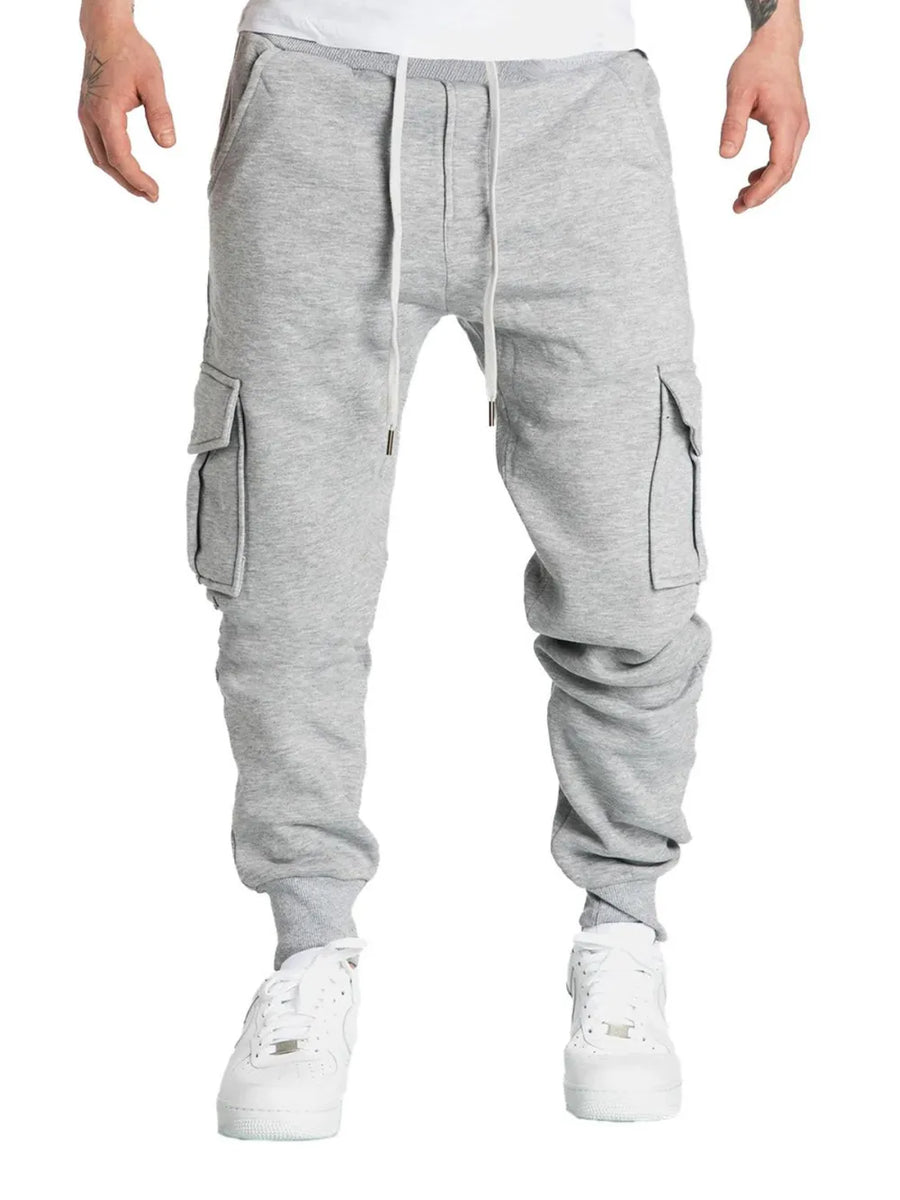 Gray cargo joggers with cuffed ankles and drawstring waist.