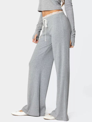 Grey lace trim wide leg pants with drawstring waist and white ballet flats.