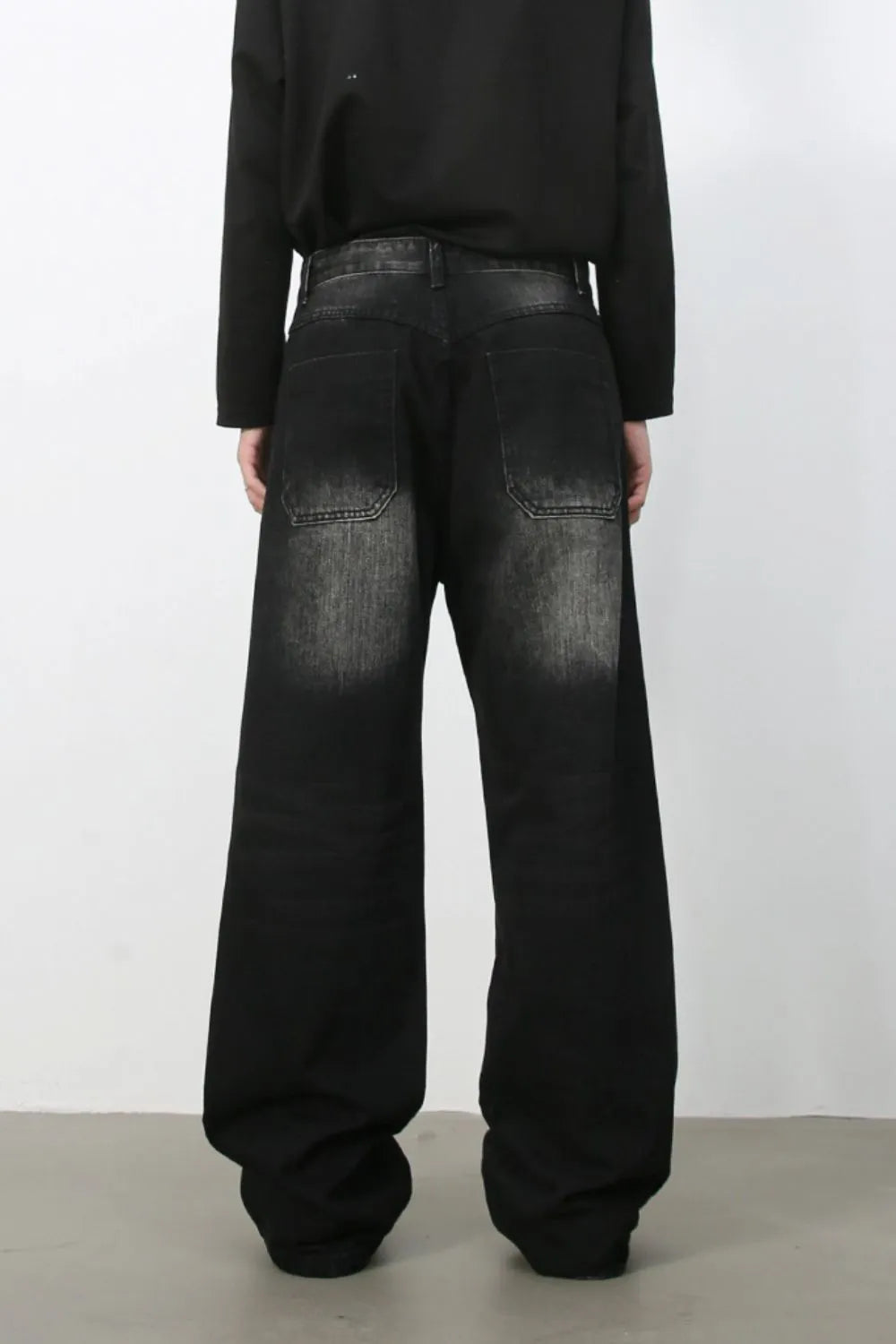 Faded wash wide-leg carpenter jeans in dark black denim with a relaxed fit.