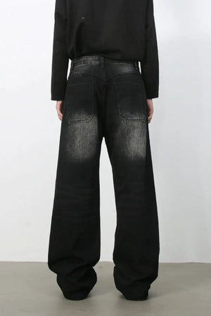 Faded wash wide-leg carpenter jeans in dark black denim with a relaxed fit.
