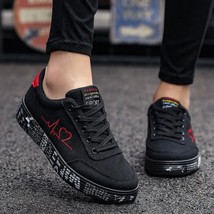 Black canvas sneakers with red heartbeat graphic and graffiti sole.