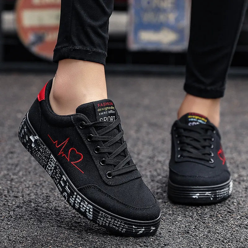 Black canvas sneakers with red heartbeat graphic and graffiti sole.