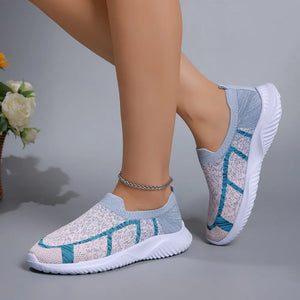 Geometric knit slip-on trainers in light gray and yellow with blue accents.