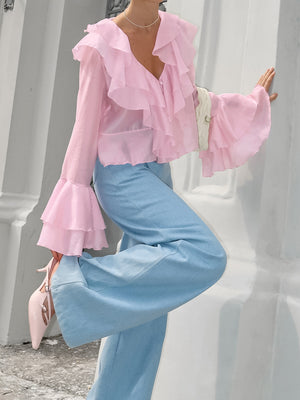 Blush pink ruffle trim long sleeve blouse with dramatic sleeves and a deep V-neck.