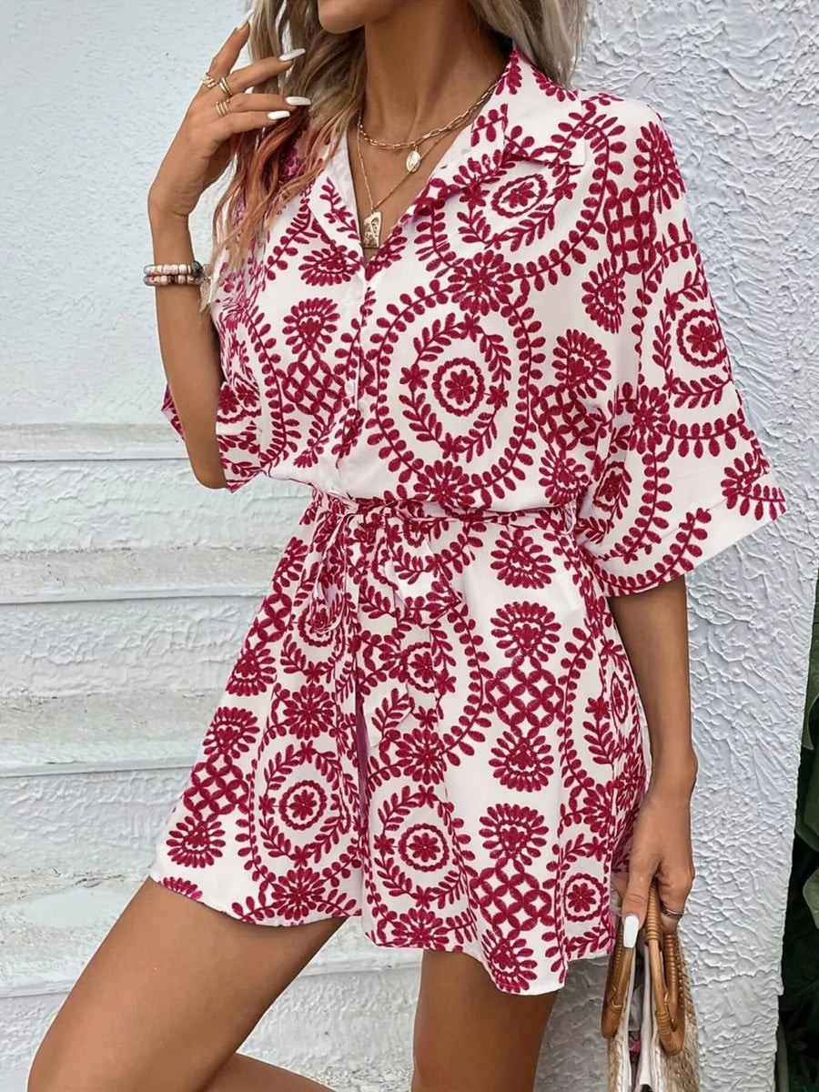 Deep Red printed tie-waist romper with button front and spread collar.