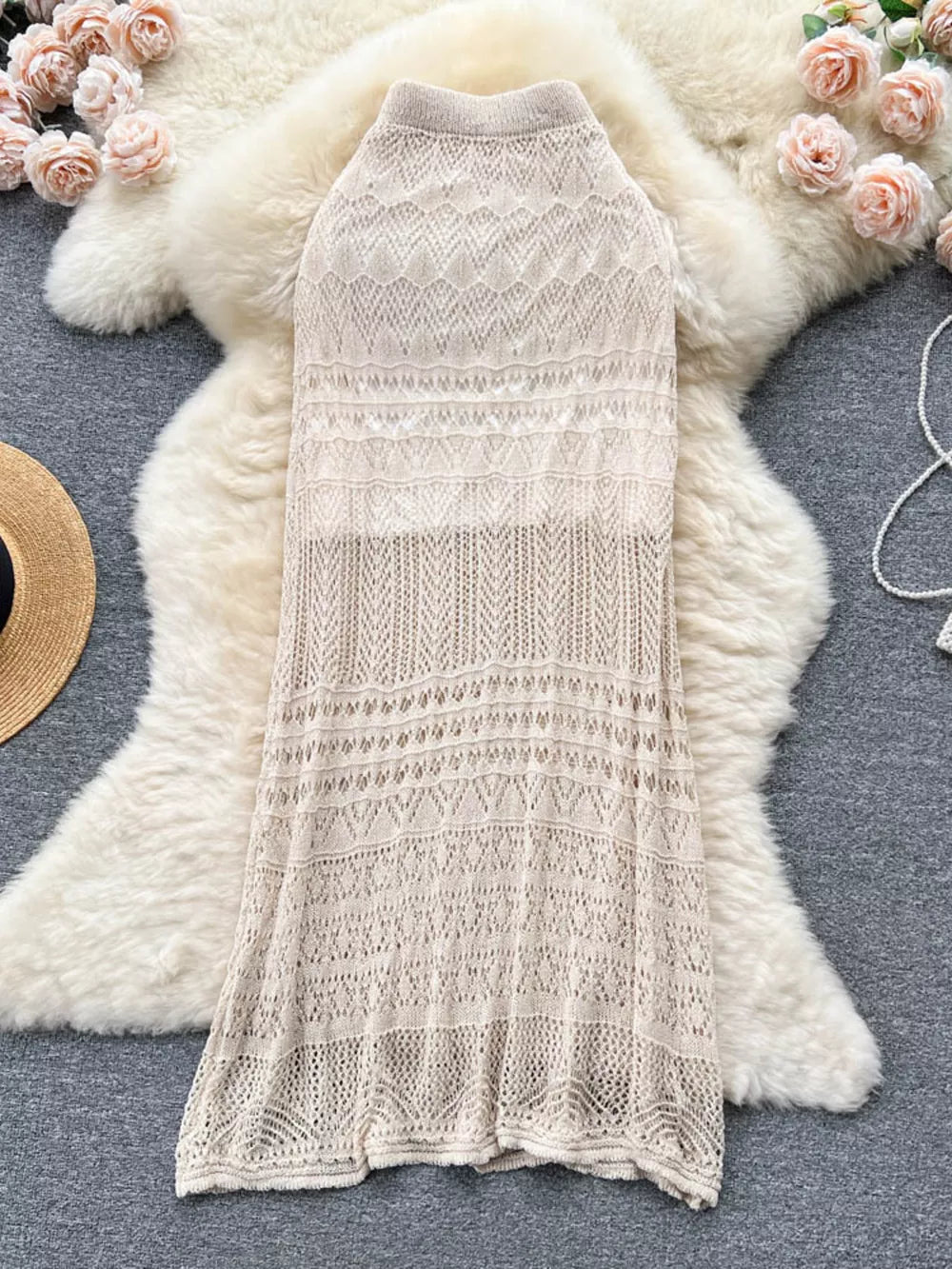 Apricot openwork knit maxi skirt with intricate patterns and a high neckline.