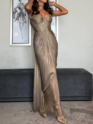 Gold metallic corset maxi gown with draped pleated skirt and lace-up back.