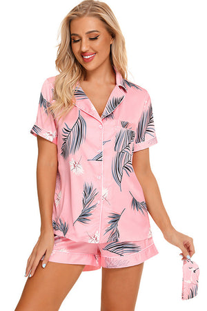 Pink botanical print satin pajama set with button front and shorts.