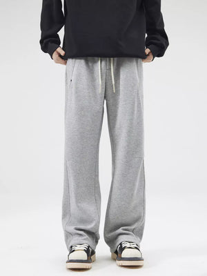 Grey casual loose-fit men's sweatpants with drawstring and pockets.