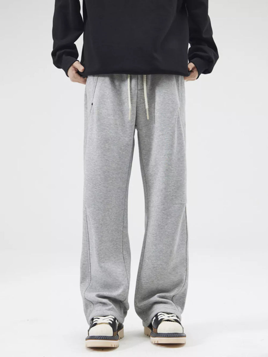 Grey casual loose-fit men's sweatpants with drawstring and pockets.