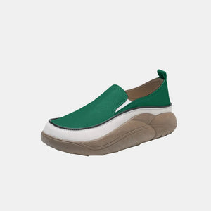 Turquoise slip-on sneakers with sculpted platform sole and white trim detail.