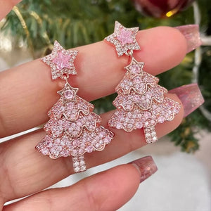 Festive Holiday Tree Earrings in blush pink with star accents, adorned with delicate shimmering stones.