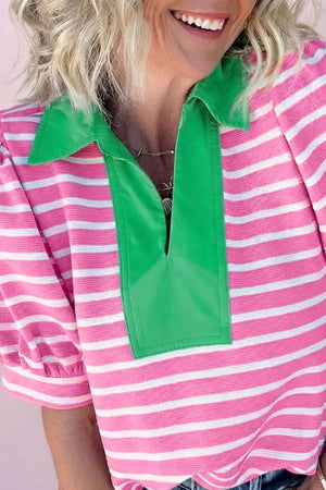 Pink and white striped cotton polo shirt with a green collar and placket detail.