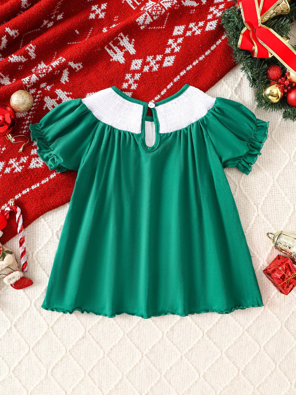 Green A-line baby dress with smocked white collar, puff sleeves, and keyhole back.