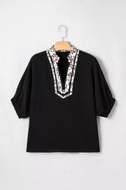 Black tunic shirt with leopard print notched neckline and short sleeves