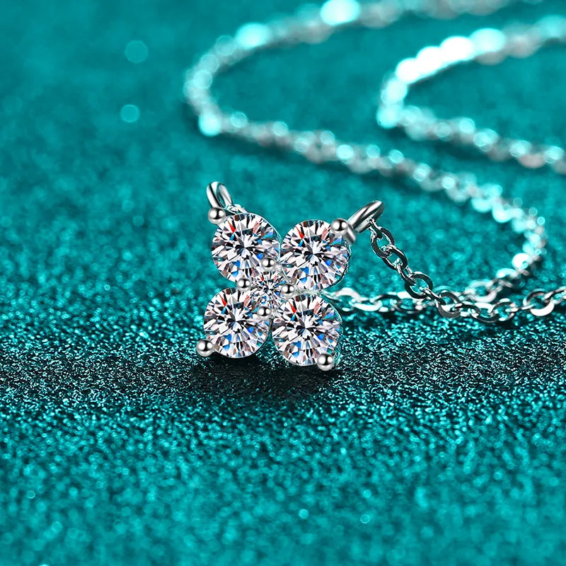Silver four-stone moissanite clover necklace with delicate chain.