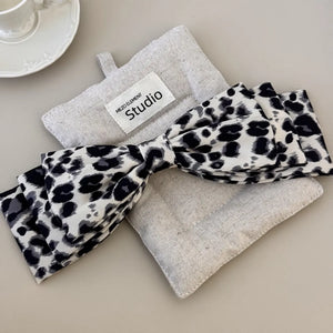 Leopard print oversized hair bow with a fabric band.