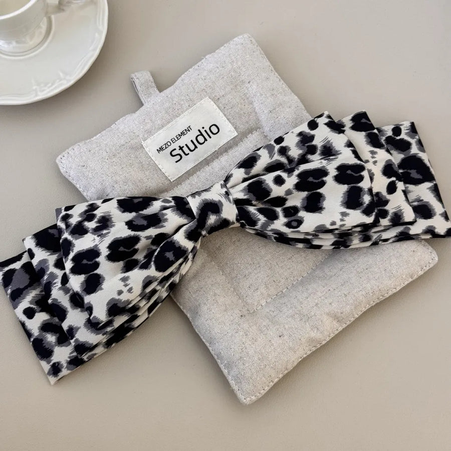 Leopard print oversized hair bow with a fabric band.