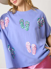 Blue t-shirt with all-over sequin flip-flop print, short sleeves, crew neck.
