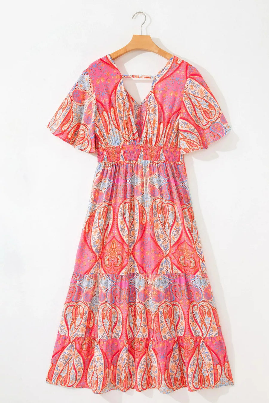 Paisley print boho dress with V-neck, short sleeves, smocked waist, and tiered skirt in burnt coral.