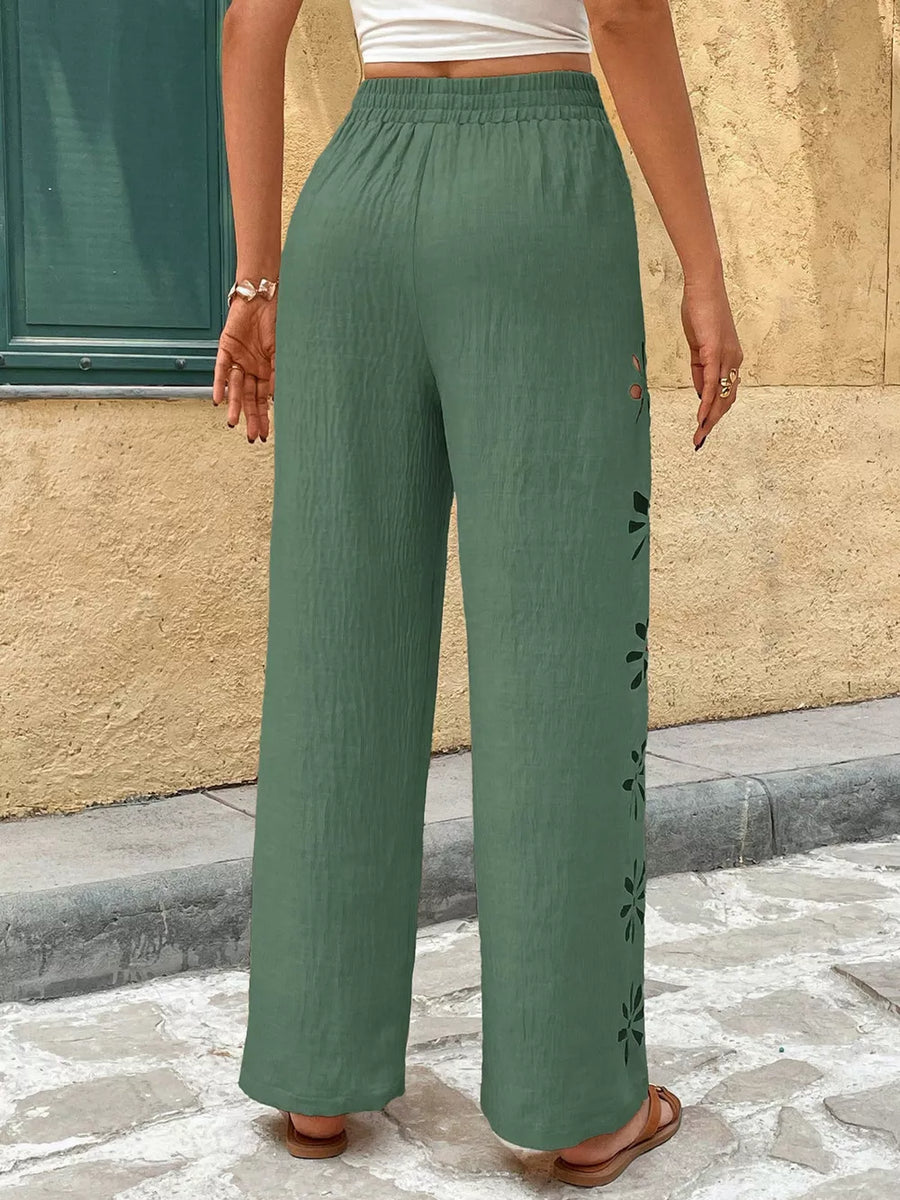 Green wide leg pants with floral cutouts and elastic waist