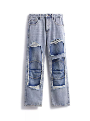 Men's light wash cotton jeans with distressed patchwork details and frayed edges.