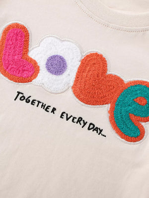 Toddler t-shirt with chenille LOVE graphic and embroidered text.