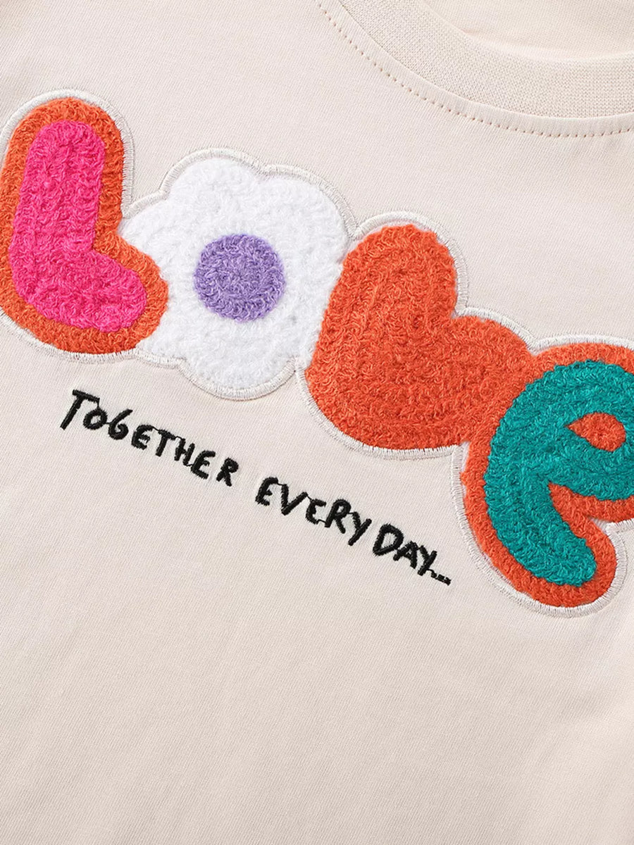 Toddler t-shirt with chenille LOVE graphic and embroidered text.