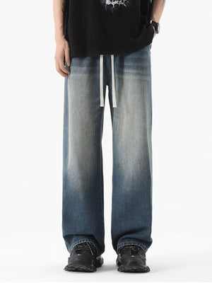 Vintage wash wide-leg jeans in light blue with drawstring waist.