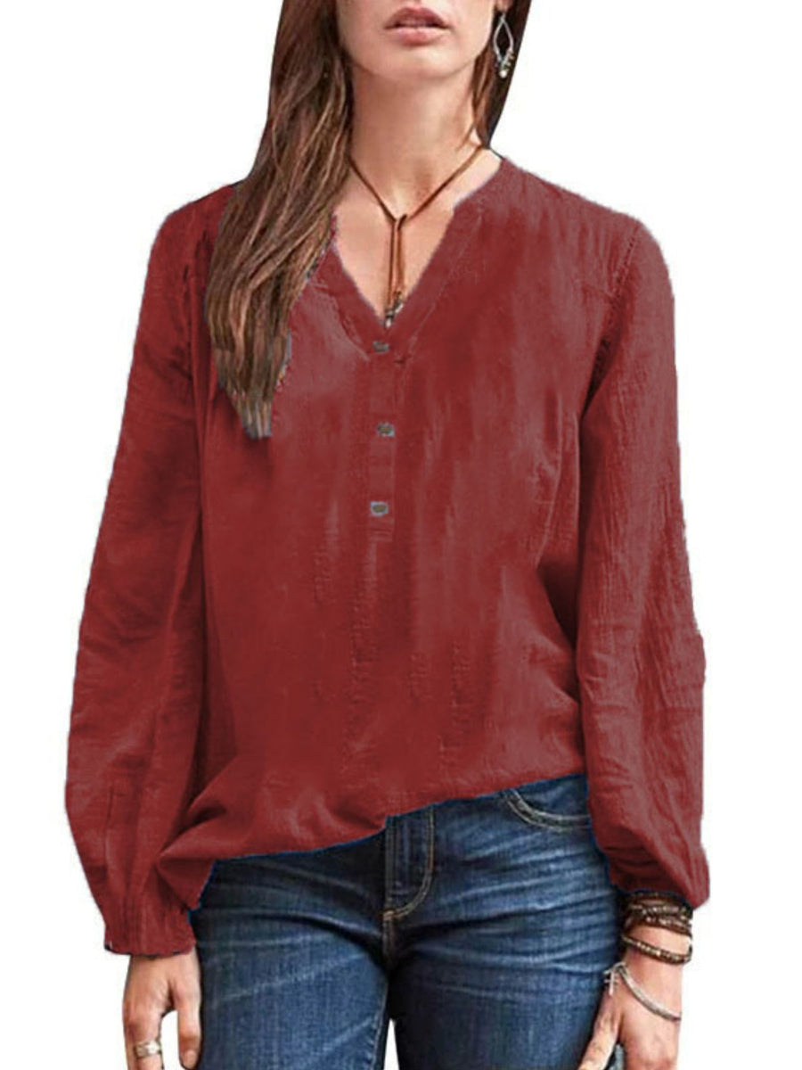 Burgundy long-sleeve blouse with notched neckline and button detail