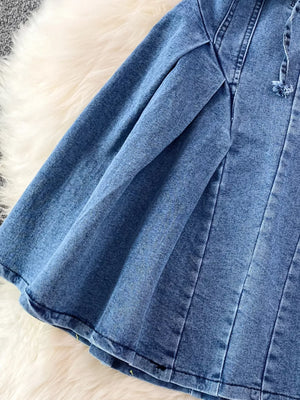 Blue denim A-line dress with corset detail and adjustable drawstring.
