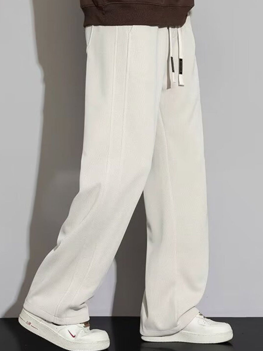 Men's apricot casual loose fit sweatpants with drawstring waist and wide leg.
