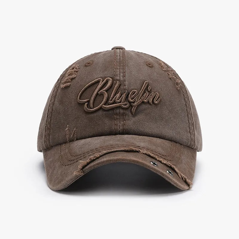 Chocolate cotton baseball cap with distressed details and embroidered text