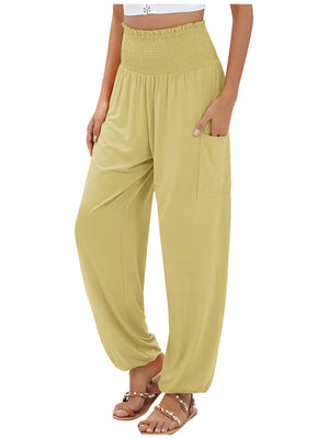 Yellow smocked waist harem pants with pockets and ankle cuffs.