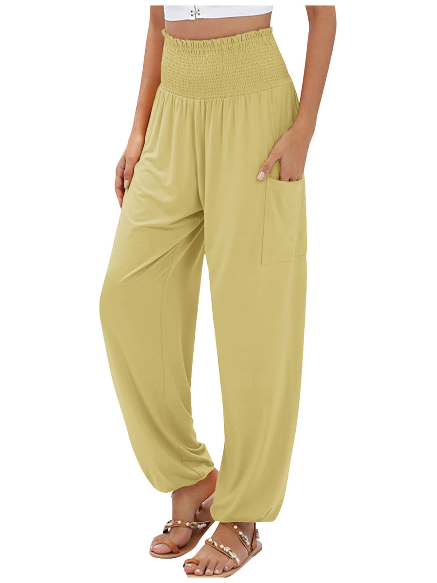 Yellow smocked waist harem pants with pockets and ankle cuffs.