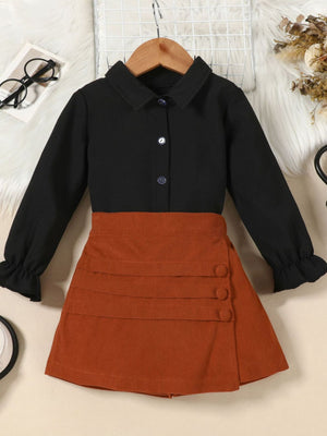 Toddler black flounce sleeve shirt and apricot brown corduroy skort set with button detail.