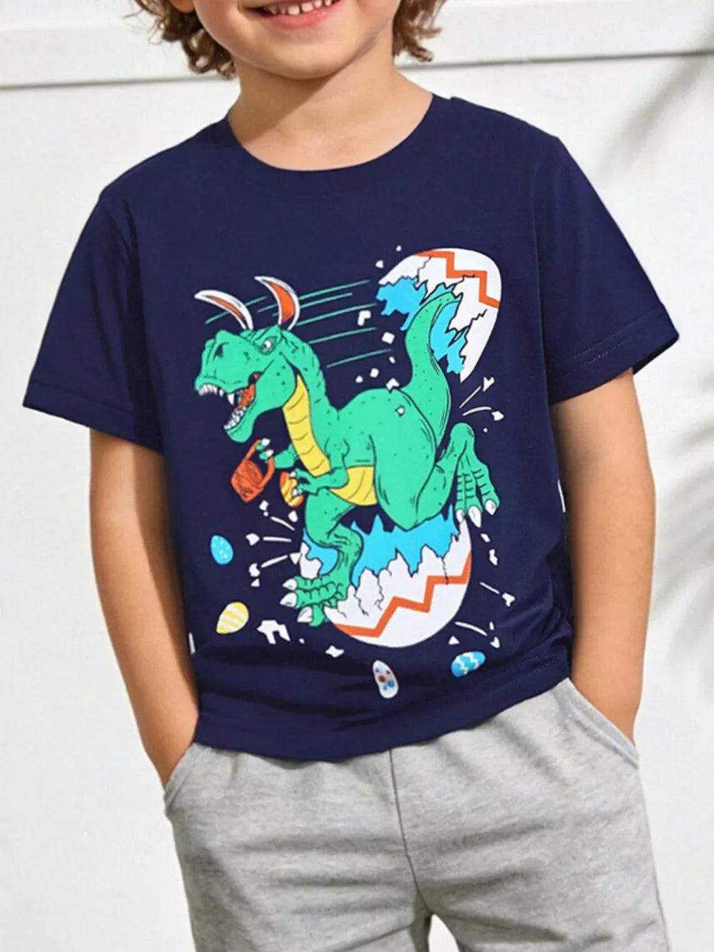Navy cotton t-shirt with a green dinosaur hatching from an Easter egg graphic.