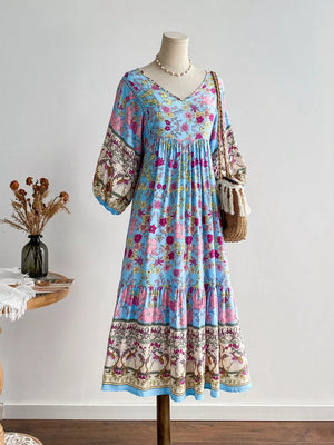 Plus-size light blue floral v-neck tiered midi dress with balloon sleeves.