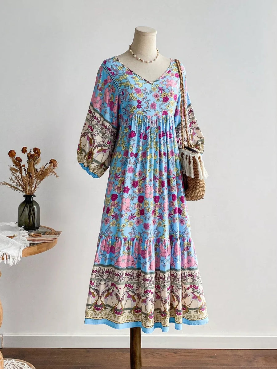 Plus-size light blue floral v-neck tiered midi dress with balloon sleeves.