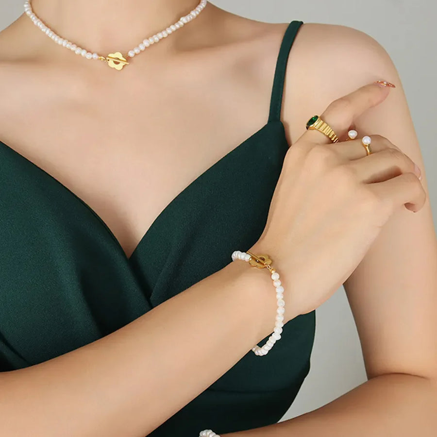 Pearl Petal Pearl Bracelet in gold with toggle clasp, styled on a model.