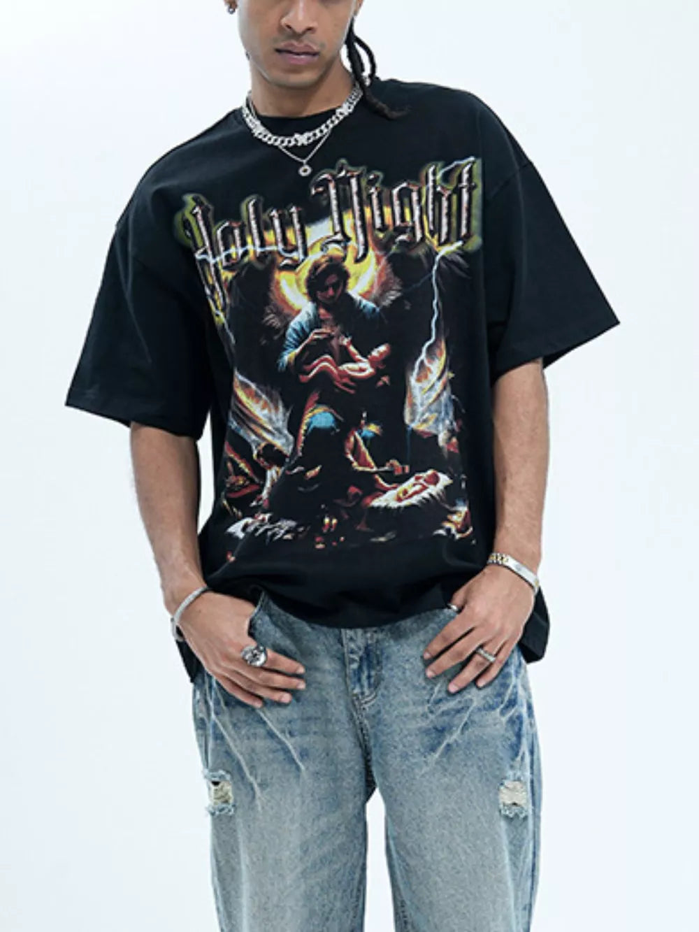 Black oversized graphic t-shirt with Holy Night print and distressed denim jeans.