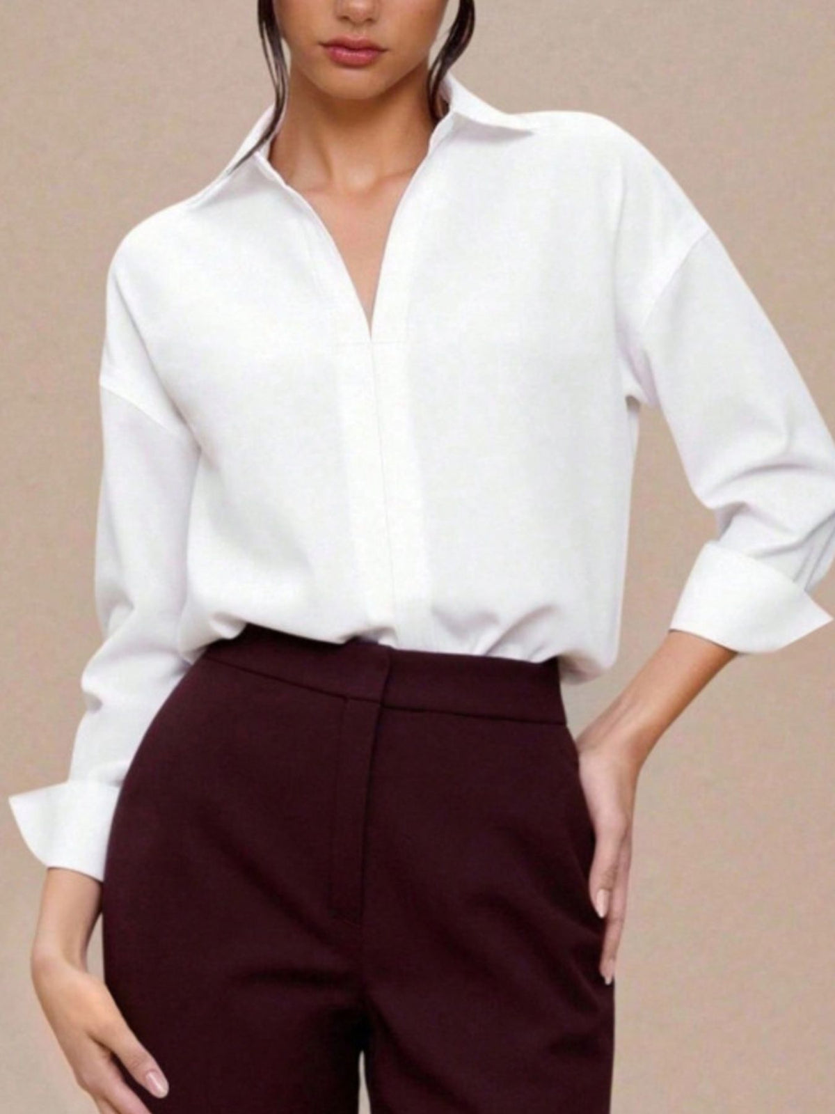 Classic collared long sleeve white bodysuit with button-down front and cuffed sleeves.