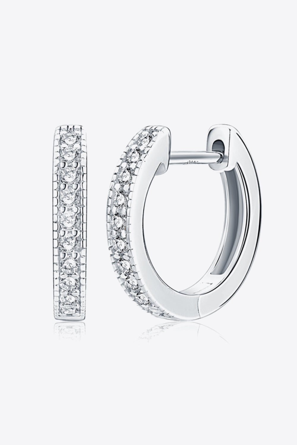 Silver pave-set huggie hoop earrings with sparkling stones.