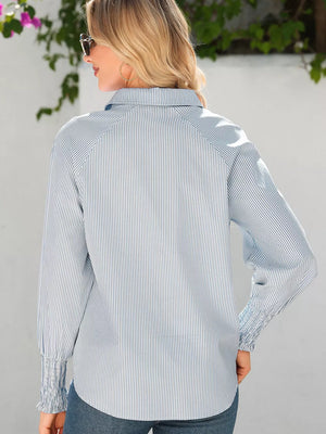 Blue and white striped collared shirt with ruched cuffs and a relaxed fit.