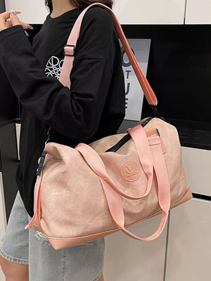 Pink Oxford cloth duffel bag with pink straps and a detachable strap.